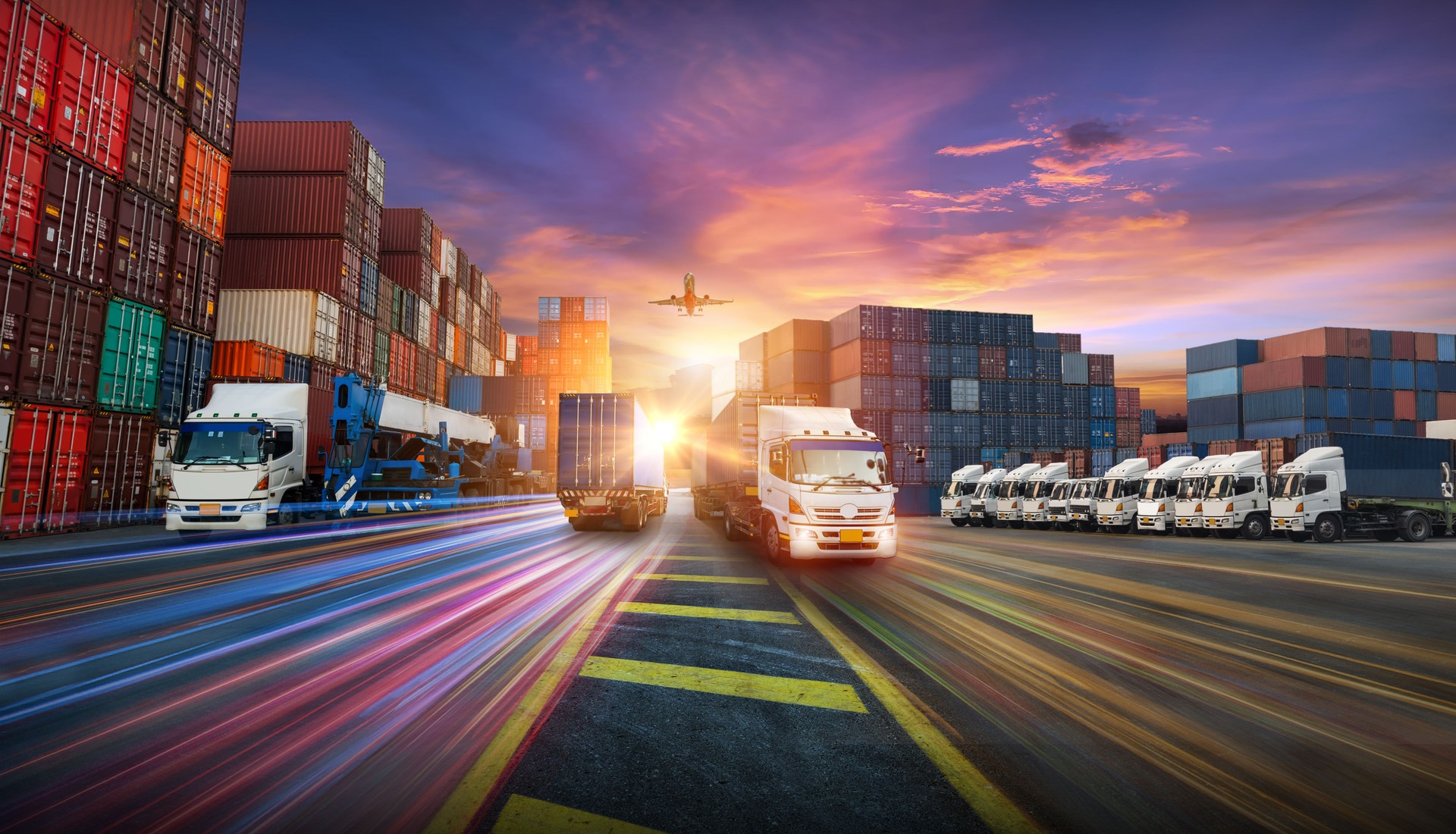 Container truck in ship port for business Logistics and transportation of Container Cargo ship and Cargo plane with working crane bridge in shipyard at sunrise, logistic import export and transport industry background